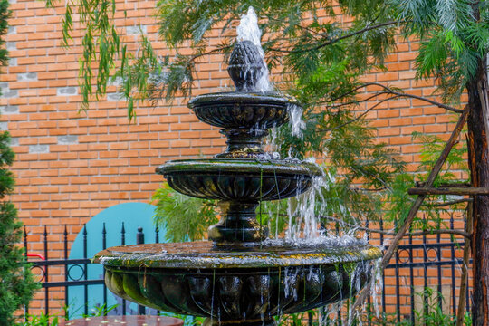 Luxury Fountain at green garden in house outdoor garden,Scenic View of a Beautiful English Style Landscape Garden in summer,selective focus.