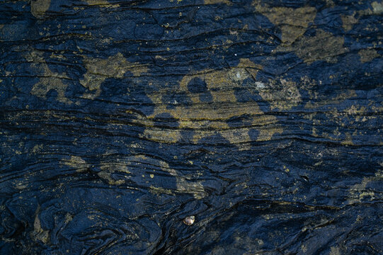 Black weathered natural stone rock background.