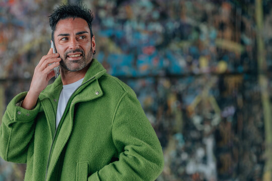 young man talking on mobile phone on the street