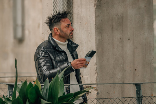 Man visiting a museum with a map or guide