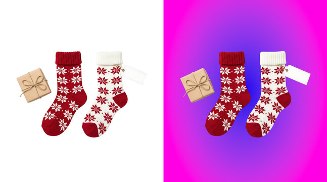 Pair of red and white knitted christmas socks with snowflake patterns and a small brown gift box with twine, isolated on white background