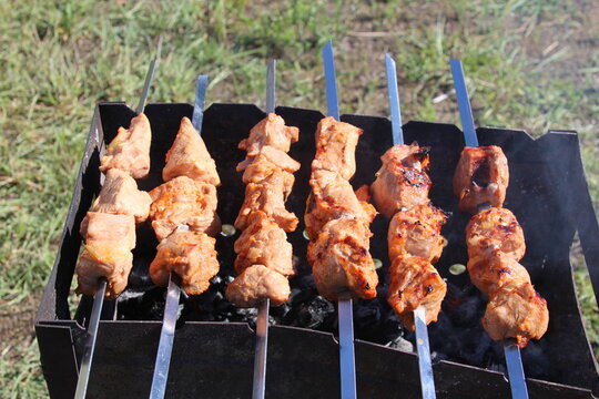 Warsaw, Poland,May 15, 2026. Top view of delicious pork shish kebabs roasting on metal skewers over coals in Warsaw. High quality photograph