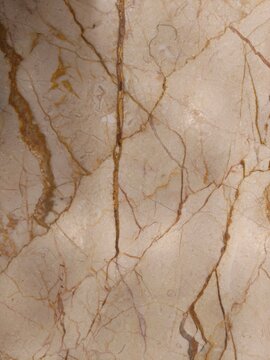 Polished beige marble stone texture with natural brown and yellow veins detail pattern surface for interior kitchen countertop or ceramic tiles design.