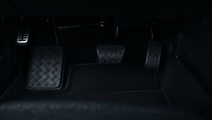Fototapeta premium Car pedals in a vehicle cabin, accelerating, braking, and clutching while driving, manual transmission concept