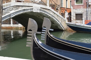 The iron prow piece of two gondolas in Venice. © Jose