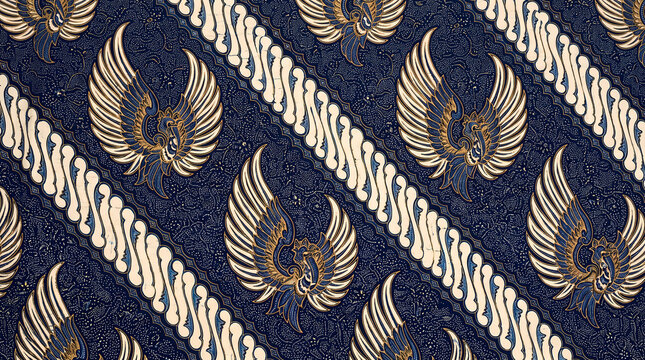 Traditional Indonesian batik pattern with parang and garuda wing motifs on dark blue fabric.
