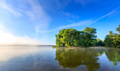 Obraz premium Blue sky reflects on calm lake surface