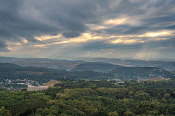Fototapeta premium Layers of green mountains and hills in the haze during sunset. Panoramic View of Green hills and Meadow.