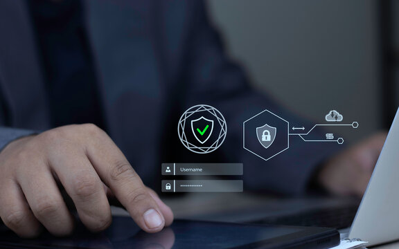 Password protection and secure login concept with businessman hand touching digital tablet displaying virtual username, password, and security shield icons on office desk.