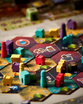 Covenant board game components close up featuring player board building tiles dice dwarf miniatures orc tokens and resource elements tabletop strategy game layout for hobby recreation entertainment