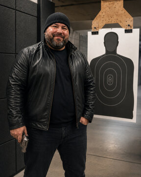 Protective Bearded Man at Indoor Shooting Range