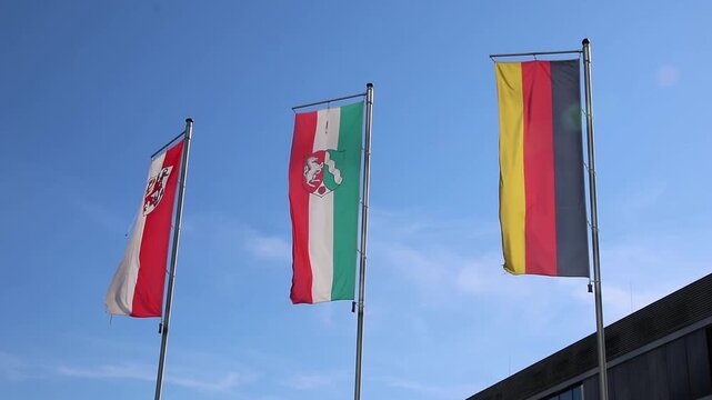 Waving flags from Germany, Northrhine Westphalia and Dusseldorf on blue sky background show european and germany represented by Germany flag, Northrhine Westphalia flag and Dusseldorf flag flags set