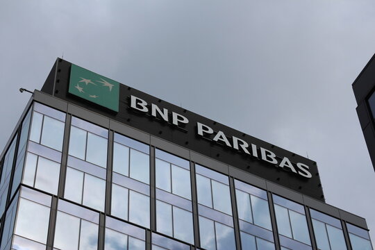 Warsaw, Poland, May 15, 2026. BNP Paribas bank logo and brand name sign on top of modern glass office building facade. High quality photograph