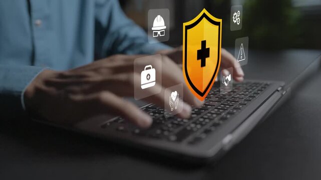 Safety first concept. Person using laptop with safety helmet, warning sign and shield icons, occupational health, risk prevention and workplace safe operating environment.