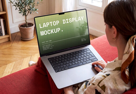 Silver Laptop Display Mockup On Burgundy Couch Editorial Home Scene