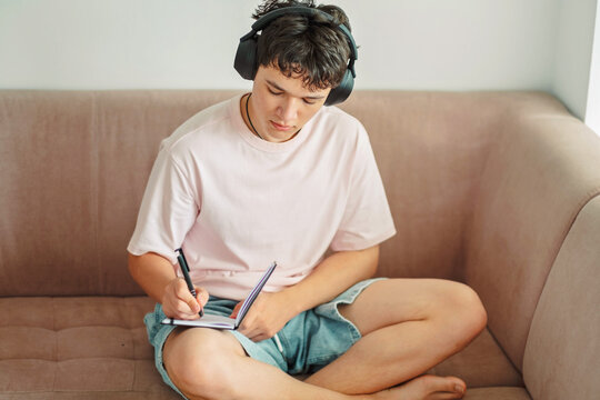 Close frame of a teenage boy writing his homework