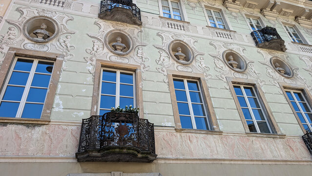 Historic decorated facade with busts of famous Italians in Bellinzona, Switzerland. 