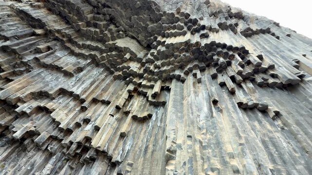 Garni, Armenia - August 26, 2026: Unique basalt rock formations showcase nature's artistry with striking geometric patterns in a dramatic landscape setting