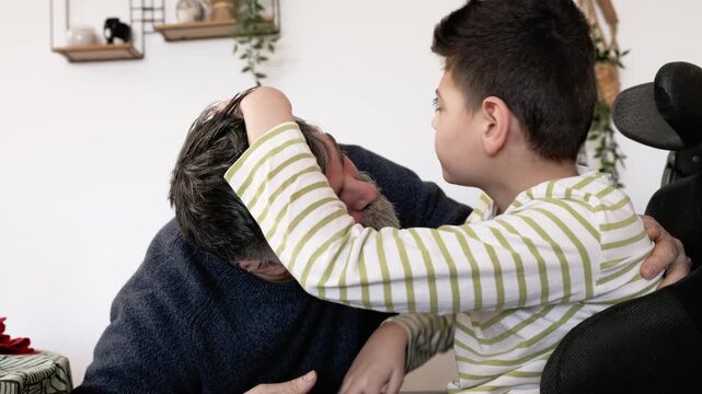 Father and disabled son with cerebral palsy sharing an emotional hug