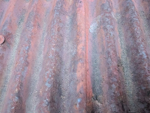 Weathered Corrugated Metal Surface with Rusty Red Patina for Industrial Backgrounds
