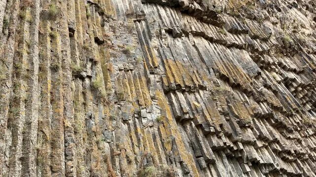Garni, Armenia - August 26, 2026: Unique geological formations of basalt columns display intricate textures and colors, highlighting nature's artistry in a stunning landscape