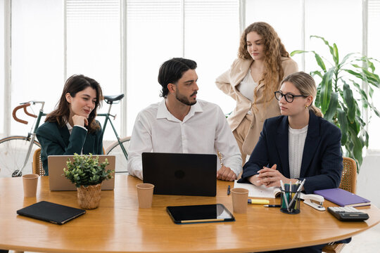 Business professionals collaborating in a modern office meeting