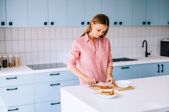 Young Woman Preparing Healthy Meal in Modern Home Kitchen, Chopping Vegetables for Lifestyle Content