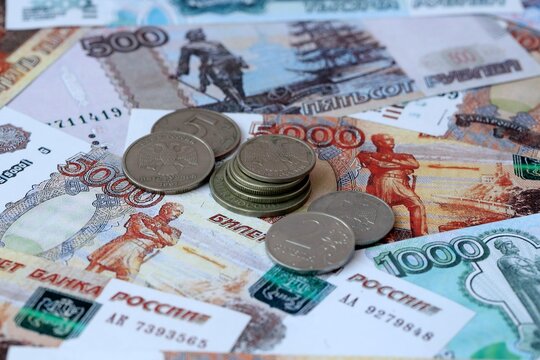 Russian rubles old money banknotes and coins on table. Russian cash bills of RUB currency
