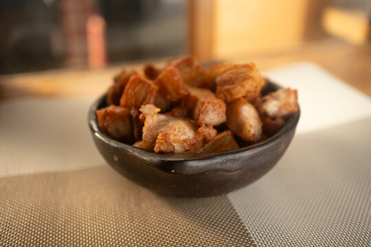 Traditional Golden Fried Pork Chunks Served in Rustic Black Clay Dish