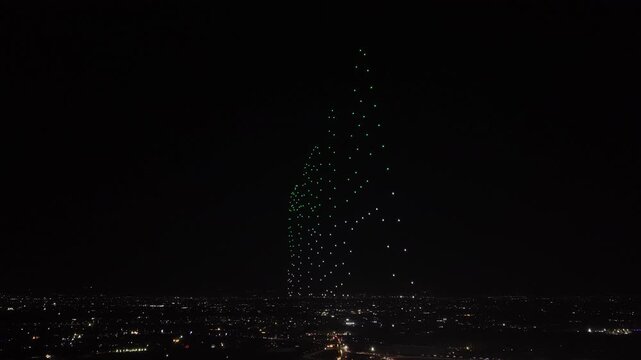 Aerial drone view of a spectacular drone light show spelling the word Syria at night. Illuminated drones forming glowing letters in the dark sky. Aerial entertainment celebrating Syrian heritage. Nigh