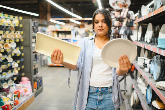 Woman shopping plates making purchase decision in store