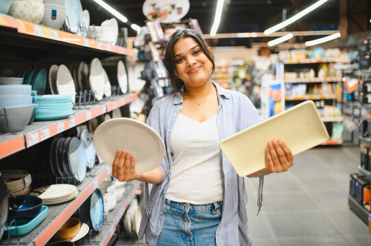 Woman shopping for new kitchenware plates at store