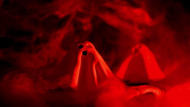 Atmospheric Halloween concept designed for seasonal greetings announcements or promotional messages combining handmade clay ghosts with classic spooky decorations to symbolize mystery, celebration