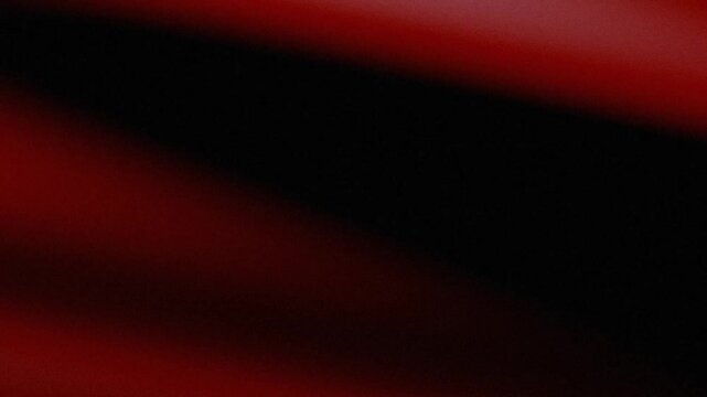 Abstract red and black grainy background with diagonal shadow gradient