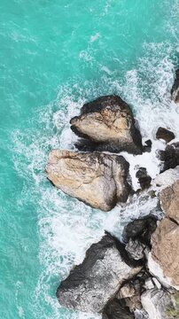 Vertical Video Turquoise Waves Breaking Over Coastal Rocks