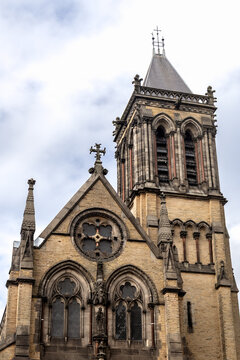 Exterior of St Wilfrid&rsquo;s Church at the York Oratory in York, England, featuring an ornate Gothic Revival facade, bell tower and arched windows beneath a cloudy sky