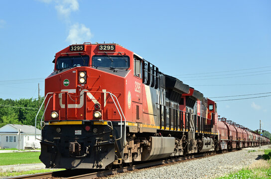 Multiple locomotives lead a Canadian National Railway freight train southbound through a small east central Illinois community.