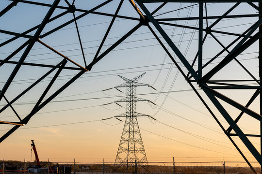 Energy grid infrastructure with high voltage pylons.