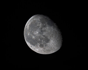 A detailed view of the waxing gibbous Moon against the dark night sky, revealing its craters, maria, and textured lunar surface © Dmytro