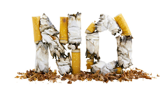 Isolated word NO made from burnt cigarettes and loose tobacco, a concept for quitting smoking.