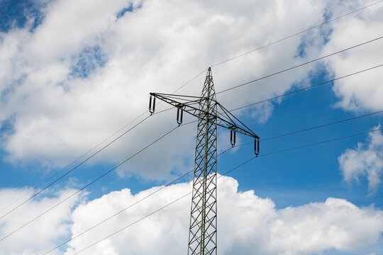 Electric voltage station. High voltage. Electricity power pylon. Electricity tower. Electrical energy. Power transmission tower. Electricity power lines and sky. Green energy