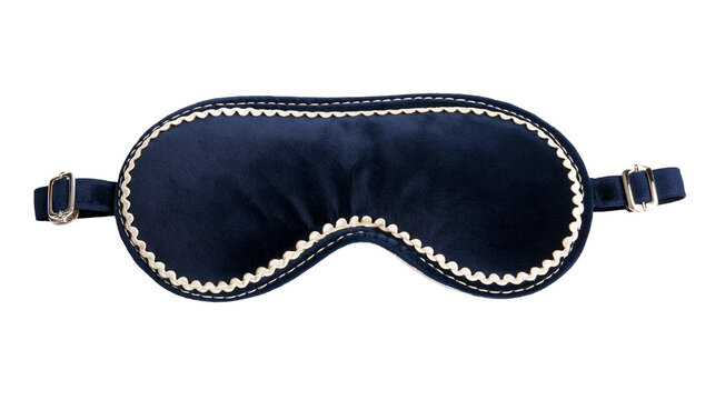 Isolated dark blue velvet sleep mask with elegant scalloped trim and gold buckles for relaxation