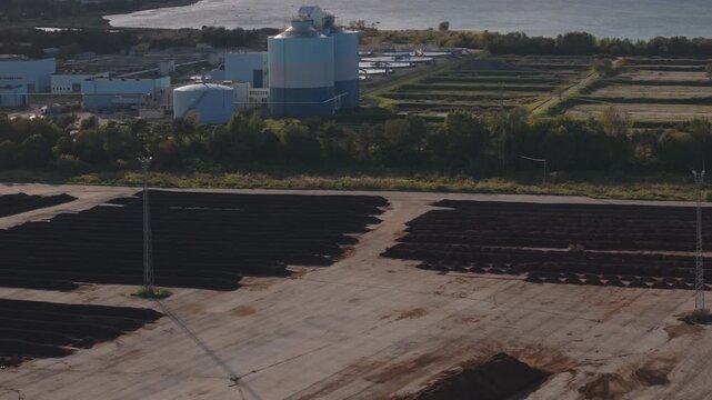 Tallinn, Estonia-September 28, 2025: Rows of treated sewage sludge (biosolids) undergoing windrow composting process at wastewater treatment facility. Recycled waste for greening and landscaping.