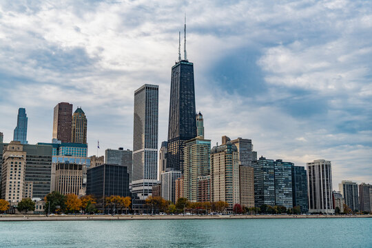 Skyscraper cityscape of metropolitan city Chicago, Illinois. Chicago cityscape with skyscraper architecture. Michigan lake with Chicago city skyline in cloudy evening. Cityscape of Chicago