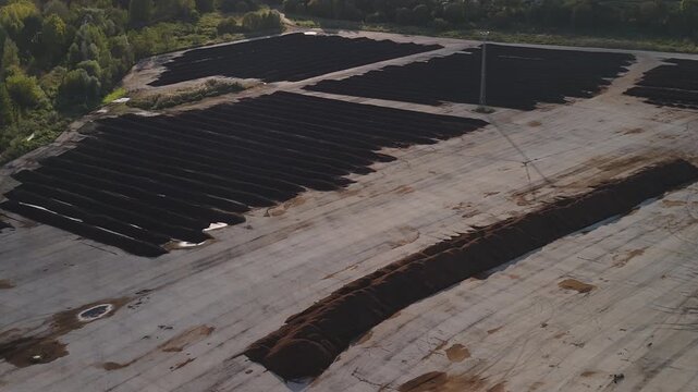 Tallinn, Estonia - September 28, 2025: Aerial perspective of composting windrows with sewage sludge, showcasing an organized industrial layout with surrounding greenery and infrastructure visible.