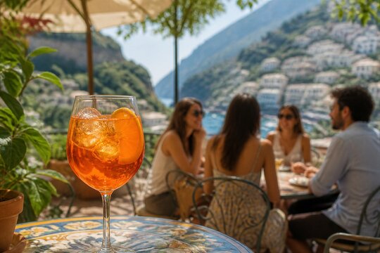 Aperol spritz glass on table with friends dining on terrace