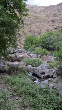 Marrakech, morocco. August 9, 2026. Majestic view of a mountain stream flowing through the rocky landscape of the ourika valley in the high atlas mountains near marrakech, morocco