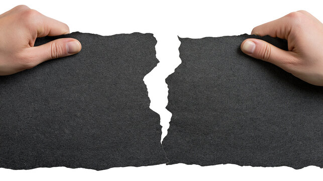 Isolated hands tearing textured dark gray paper sheet in half, symbolizing breakup