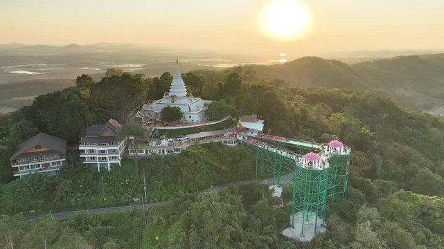 Skywalk and Phra Borommathat Phutthanimit Chedi at Wat Phrathat Pha Ngao, elevated structure combines tourism infrastructure with Buddhist landmark in year 2023