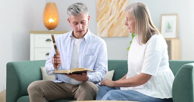 Pastor conducting Bible study with senior woman at home